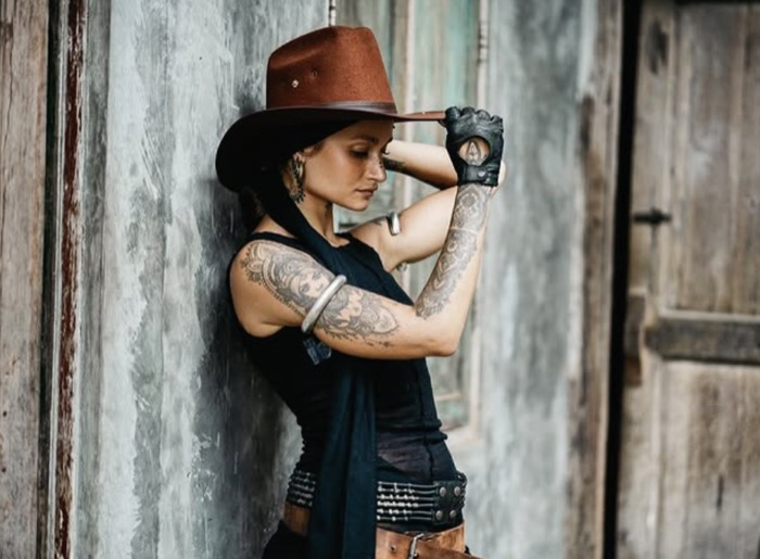 Model posed with a horse in the stable backdrop